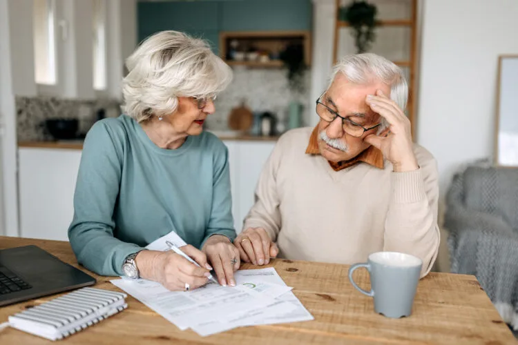 Senior couple going over bills in a domestic room